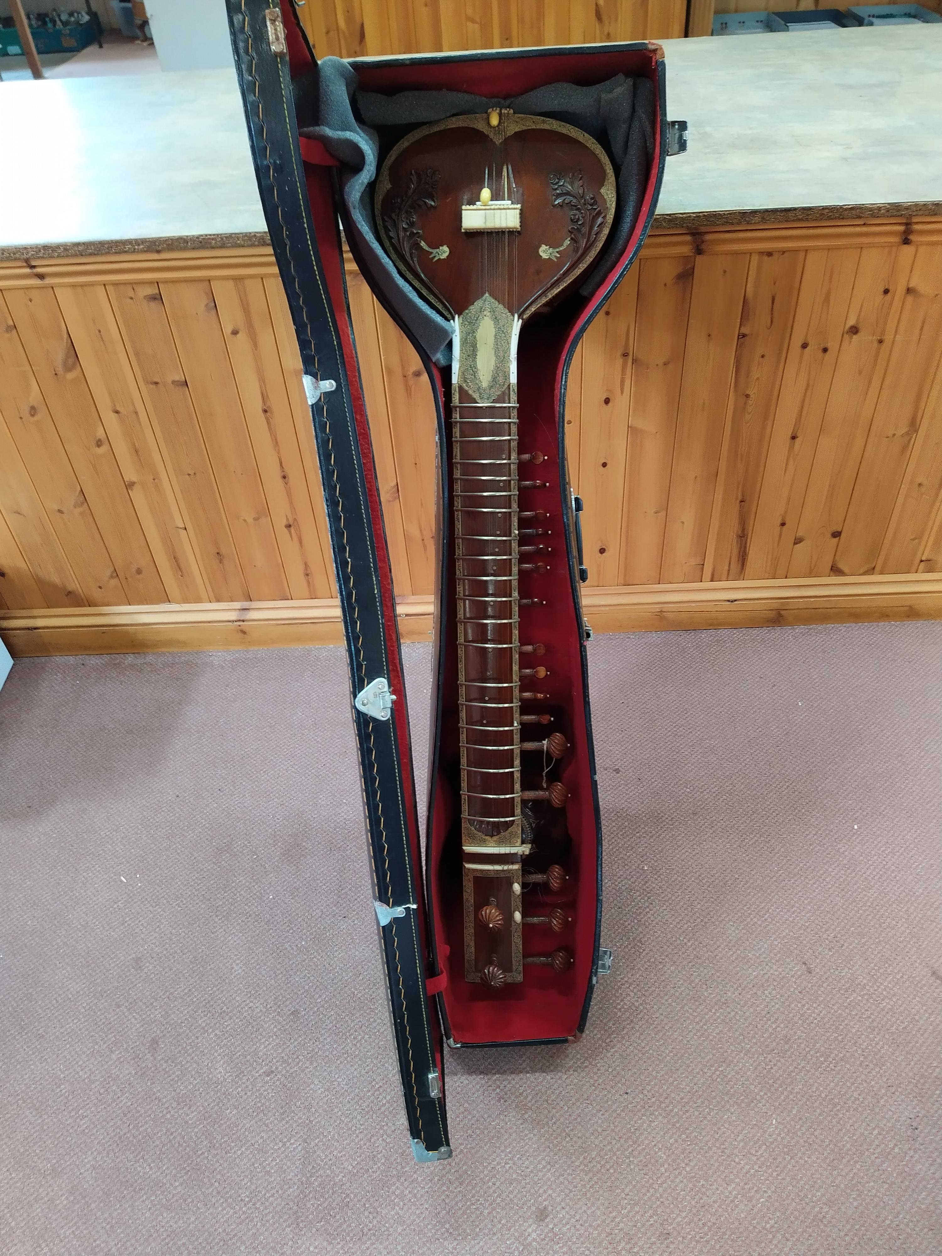 A cased vintage Indian sitar in the Ravi Shankar style with two sound boxes and extensive