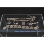 A silver watch chain, coin bracelet (as found),