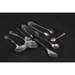 A mixed lot of silver cutlery including a sifter spoon, preserve spoon, condiment spoons and tongs,