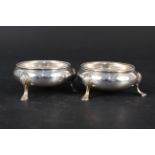 A pair of Victorian silver salts on three hoofed feet, hallmarked London 1857, makers mark RH,