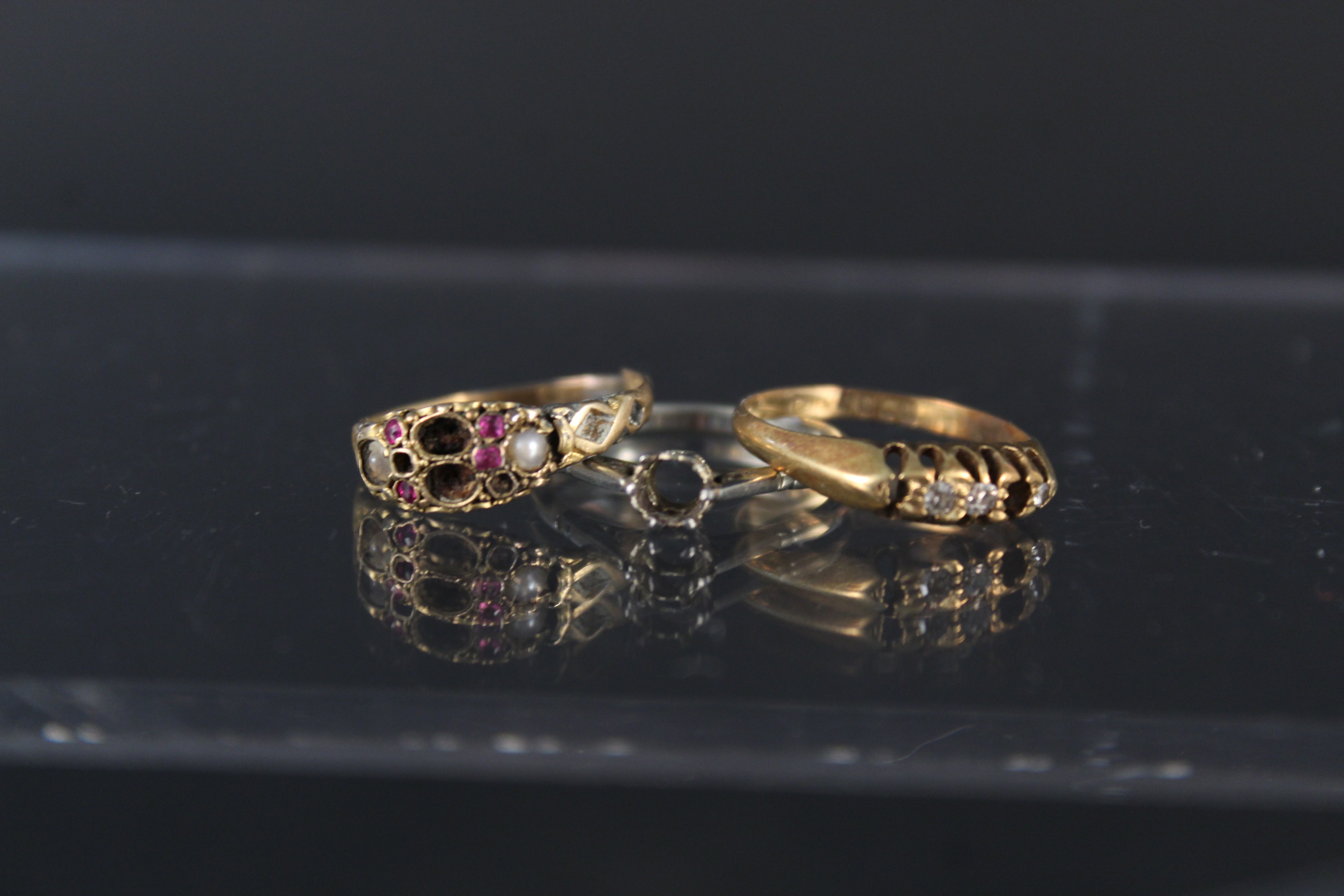 Three rings, one in 9ct gold (as found),