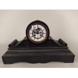 A large heavy slate mantel clock with enamel face, striking with key (some damage to enamel),