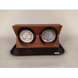 A ships style thermometer plus a humidity indicator in a hardwood frame of West German manufacture