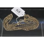 An unmarked yellow metal long guard chain,