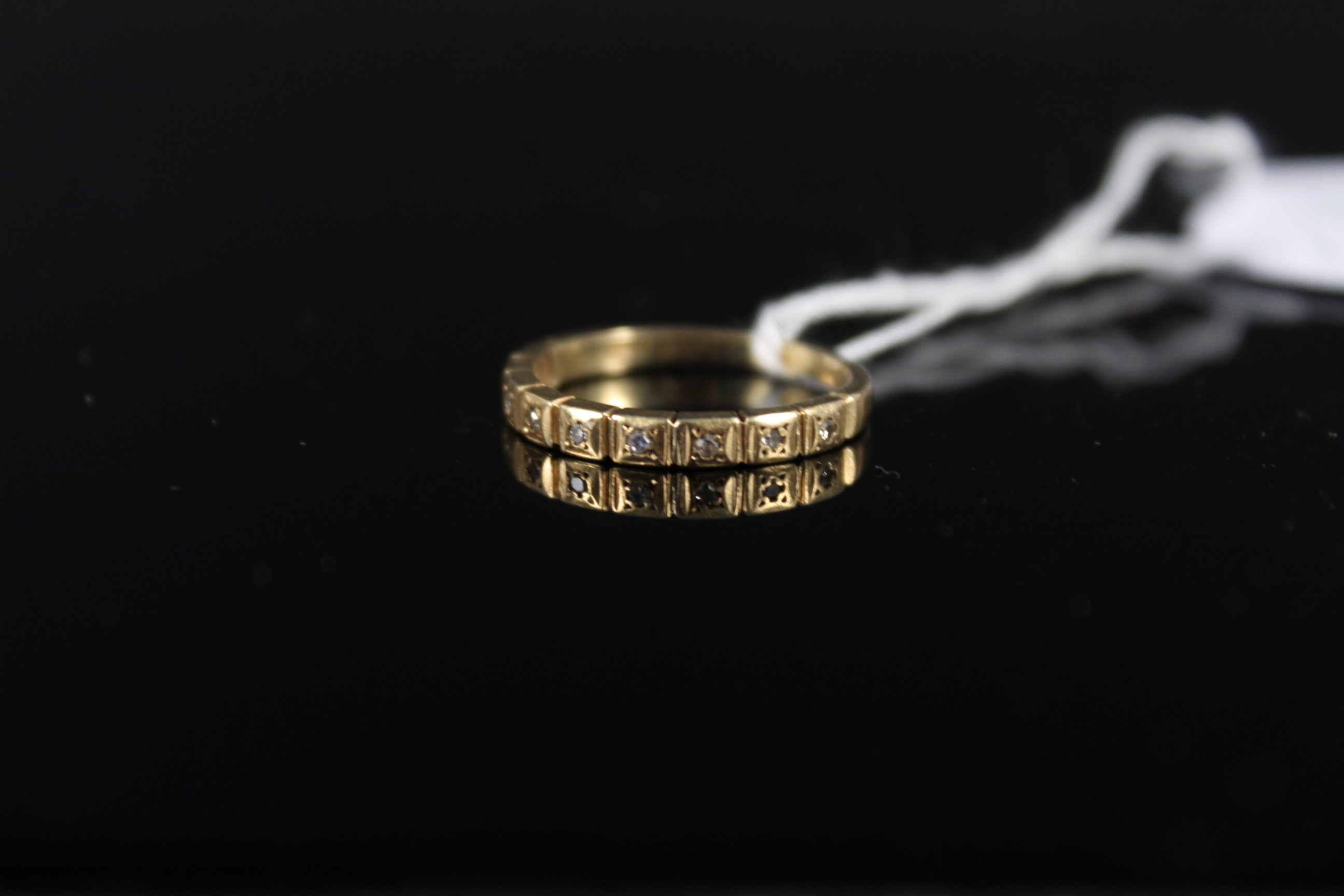 An 18ct gold half eternity ring set with small diamonds (wear to shank and setting), size J 1/2,