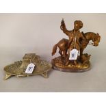 An Art Nouveau brass ink stand with ceramic well,