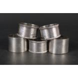 Three silver napkin rings with engraved raised decoration, hallmarked Sheffield 1903,