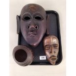 Two African carved wood face masks plus a carved coconut bowl on stand decorated with elephants