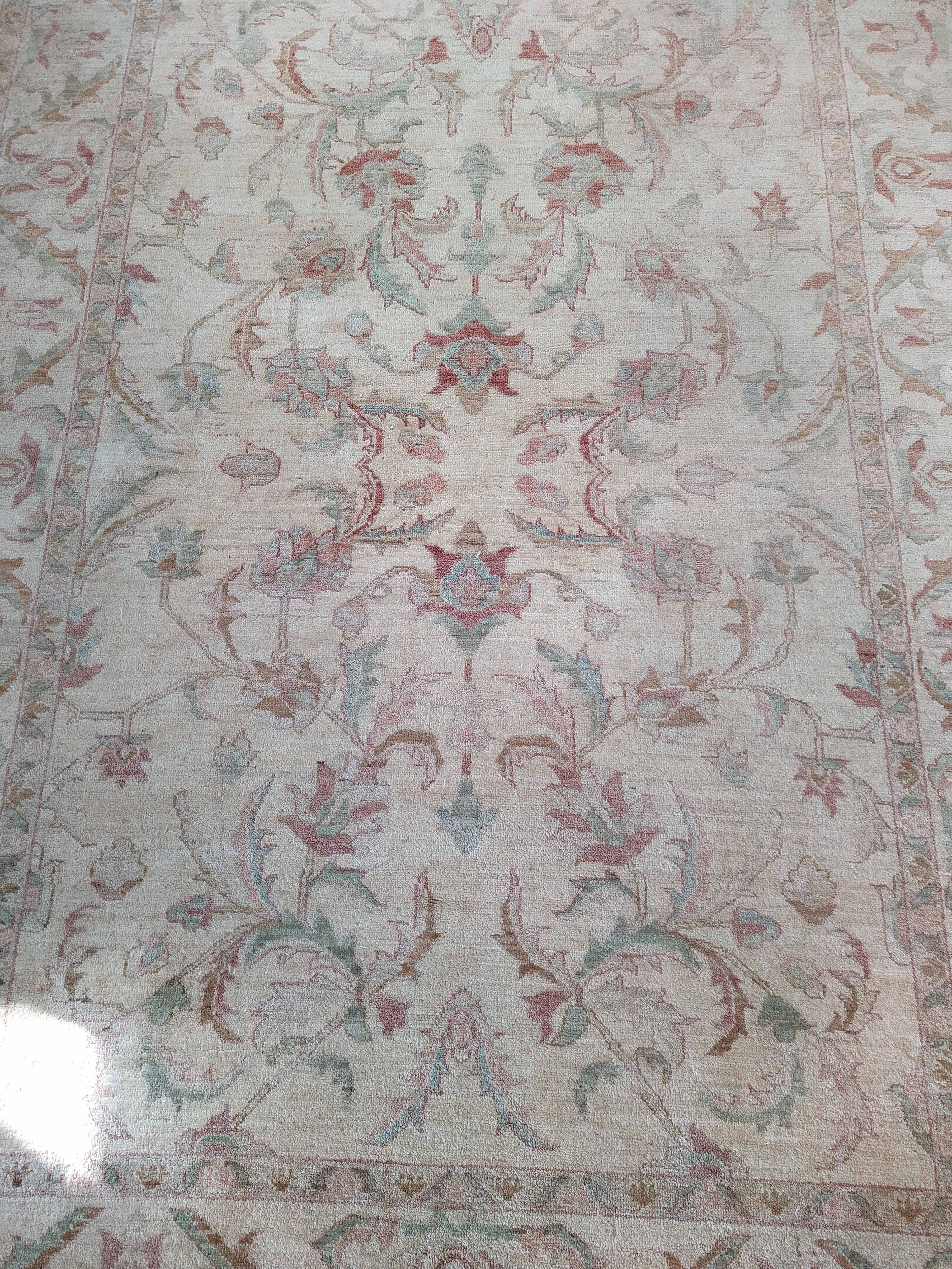 A wool rug with pale floral patterns against a beige ground, - Image 2 of 3