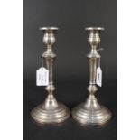A pair of filled sterling silver candlesticks, stamped Sterling to base,