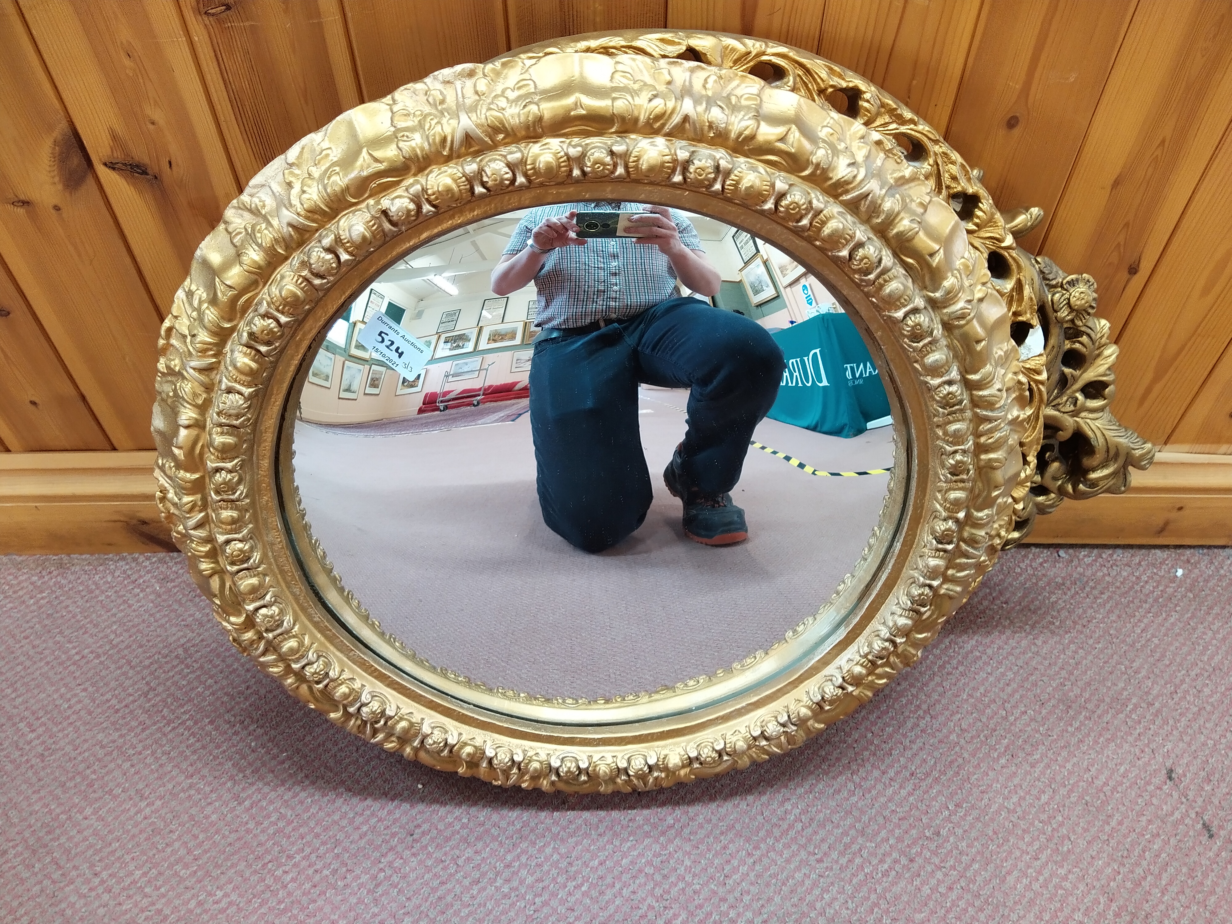 Two round and one oval gilt framed mirrors,