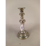 A late 18th Century Paktong candlestick with knopped stem and circular base engraved with ownership