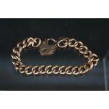 A 9ct gold curb link bracelet with heart shaped padlock clasp (repaired), weight approx 17.