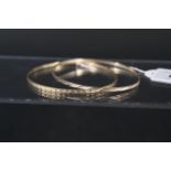 Two 9ct gold bangles with engraved decoration, weight approx 8.