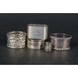 Four various silver napkin rings plus a thimble,