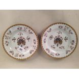 A pair of 18th Century Chinese armorial plates, hand painted and gilded with raised enamel work,