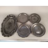Five 18th/19th Century pewter plates and dishes with touch marks and two stamped with owners