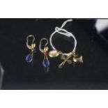 A pair of continental yellow metal earrings marked 750 with faceted blue stone drops together with