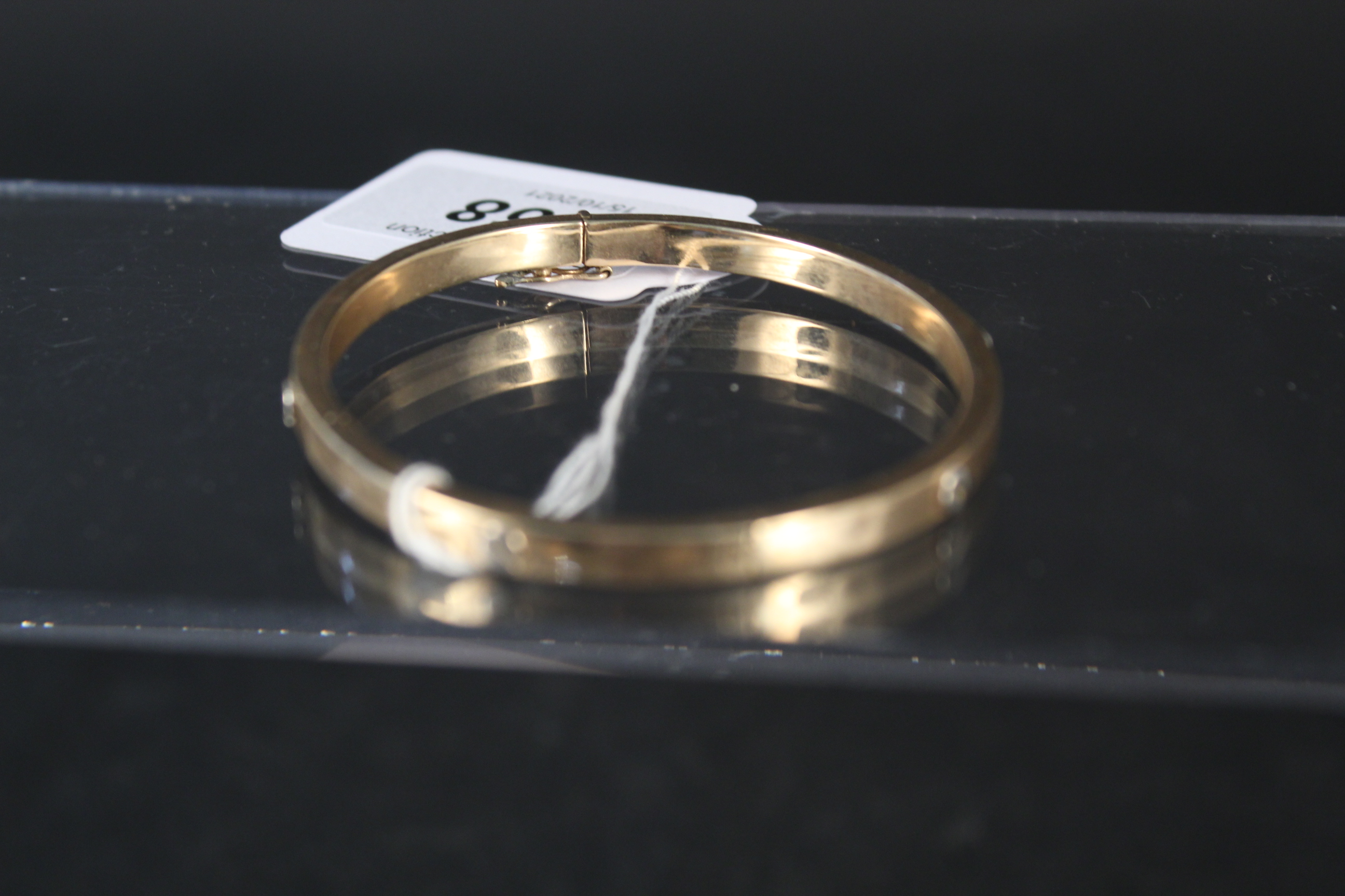 A 9ct gold bangle with 'screw' form decoration, weight approx 10. - Image 3 of 3