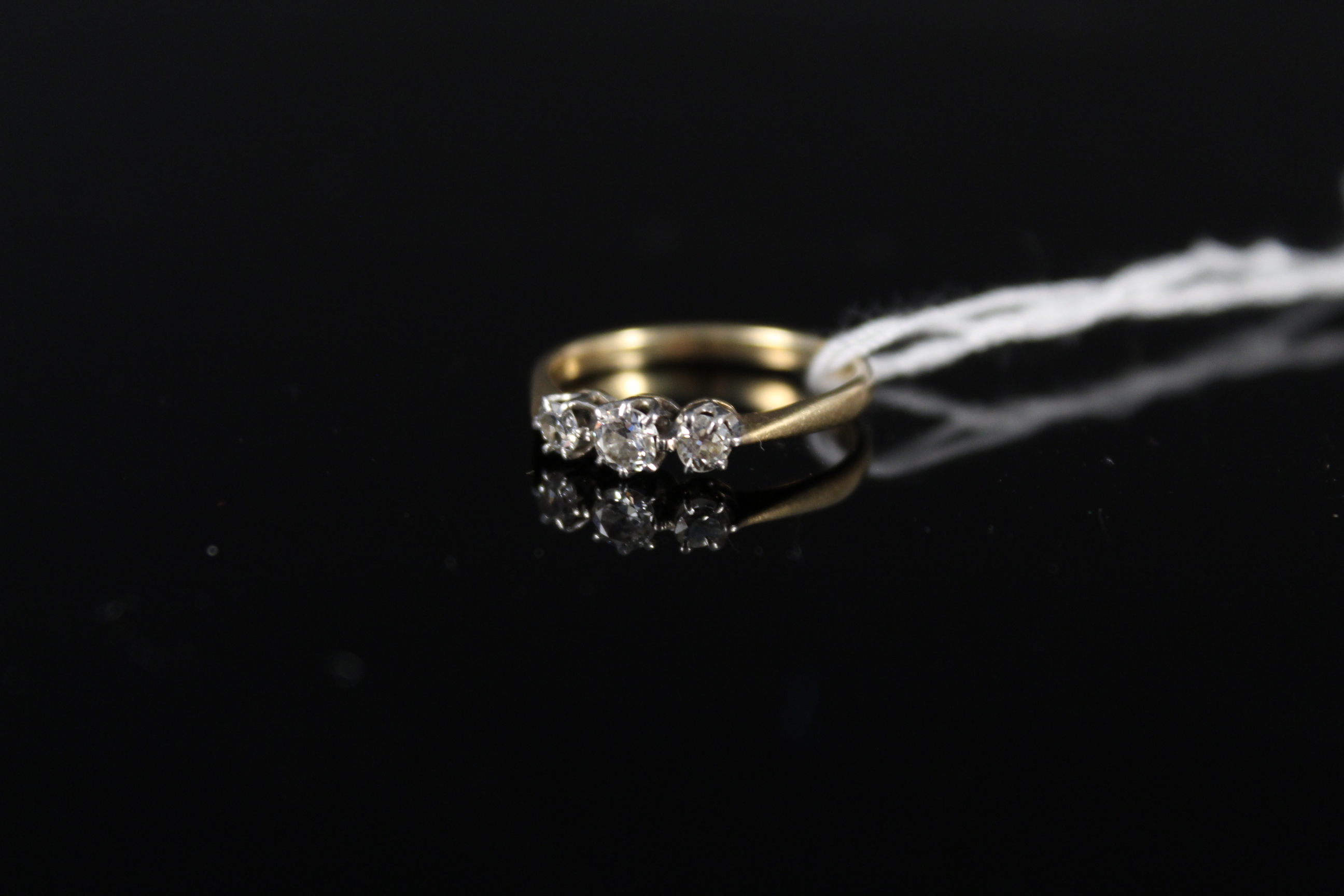An 18ct platinum set three stone diamond ring, size J 1/2,