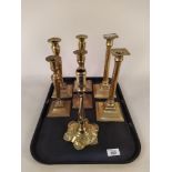 Three pairs of late 18th Century square base brass candlesticks plus a petal base brass candlestick