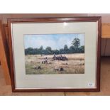 A framed watercolour of a harvesting scene,