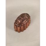 A Victorian copper jelly mould of fluted oval form,