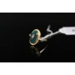 An 18ct gold ring set with oval cabochon turquoise stone,