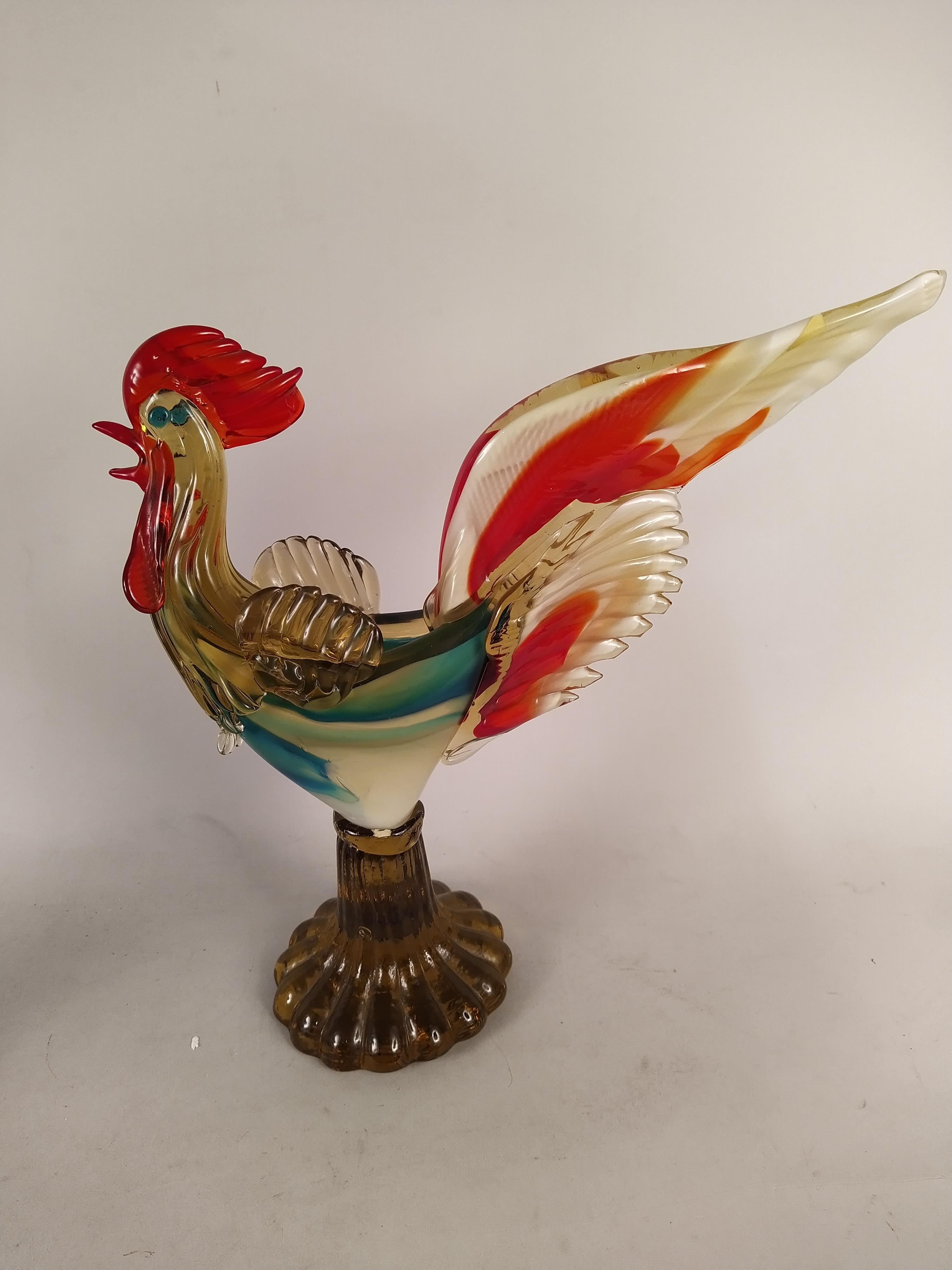 A large coloured glass cockerel, a cut glass ships decanter, a cut glass whisky decanter,