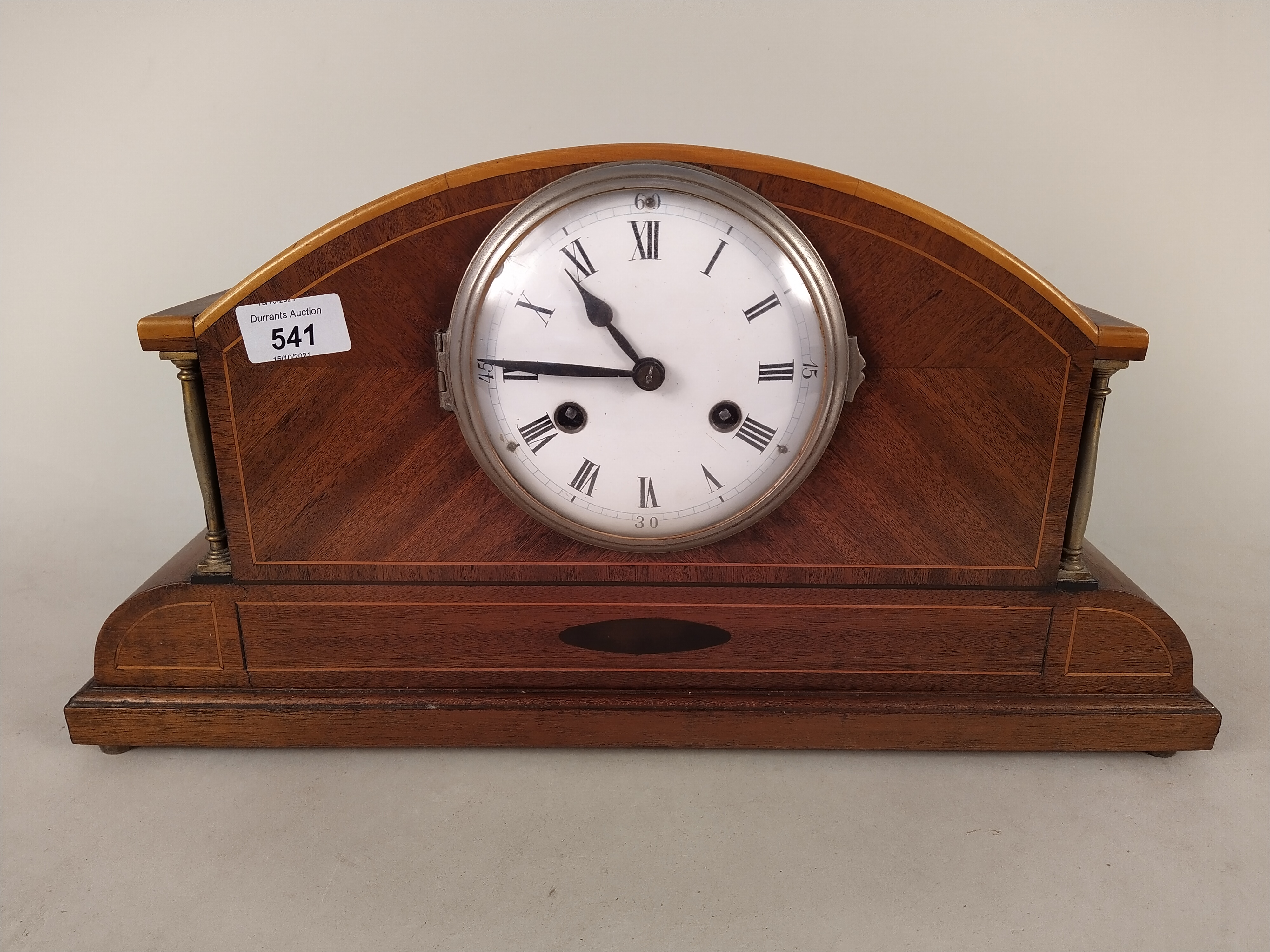 An Edwardian inlaid mahogany striking mantel clock