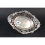 A pierced dish with ribbed and floral decorated border on four bun feet,