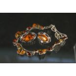 A silver amber set bracelet and similar earrings