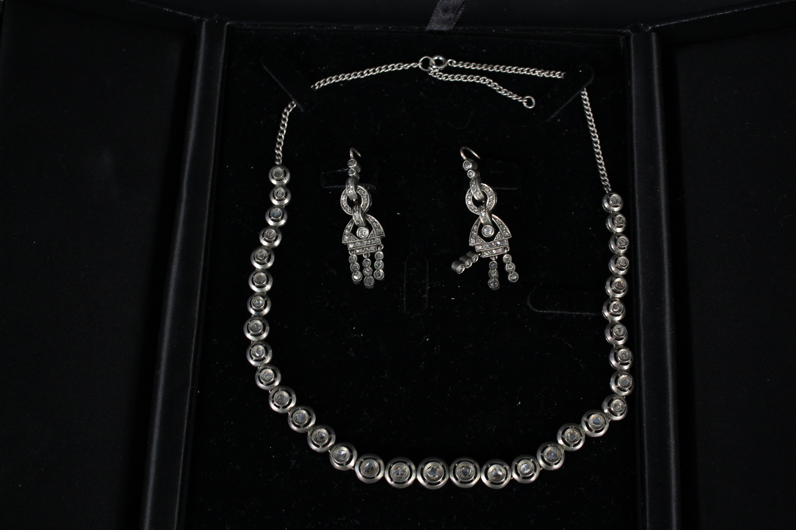 An antique white metal diamond set necklace,