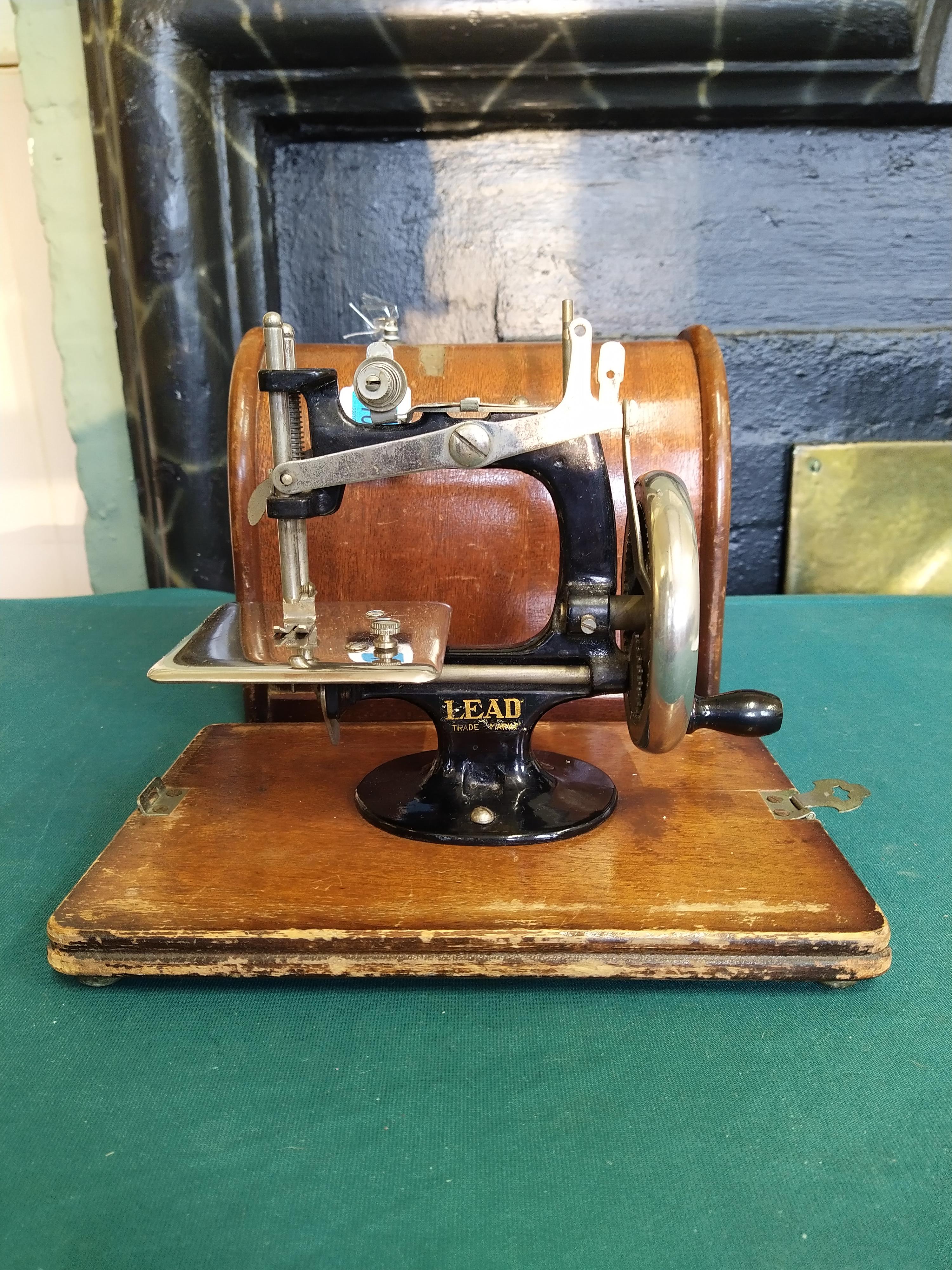 A vintage 'Lead' mini sewing machine in box