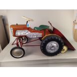 A 1960's Triang metal and plastic ride on tractor with trailer,