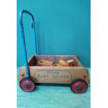 A vintage Triang baby walker with a wooden train set