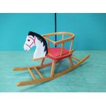 A vintage (possibly Heilag Germany) solid wood rocking horse,