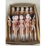 Fourteen vintage jointed limb peg dolls, hand made with painted faces, each different,