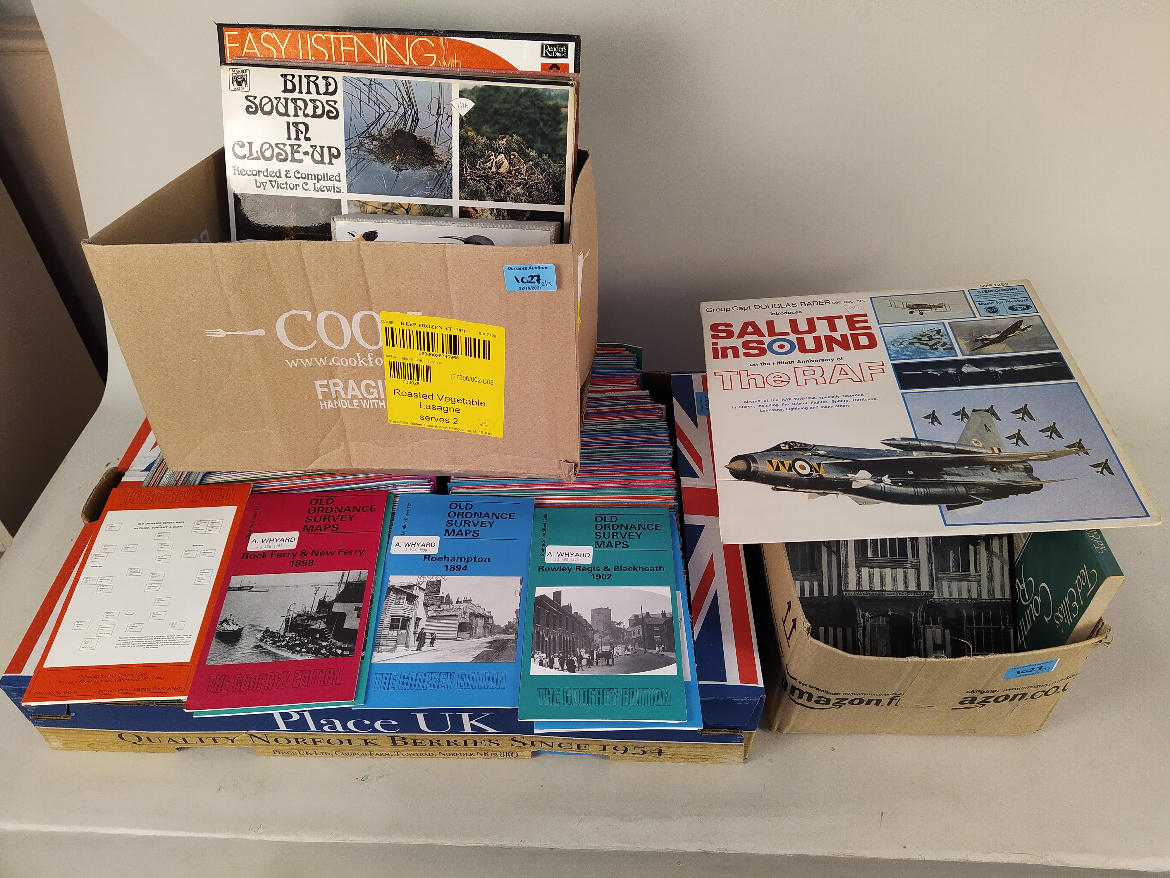 Three boxes of mixed items including many reprinted in the 90's of early ordnance survey maps from