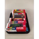Four boxed Britains 1:32 scale models including 9559 yard brush, 9433 four trax and log shed,