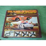 A 1980's 'Dukes of Hazzard' electric slot racing set with instructions (contents appear complete,