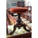 A mid 19th Century carved walnut adjustable piano stool,