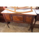 An Edwardian walnut washstand base with replaced top