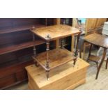 A Victorian inlaid walnut two tier table on castors