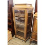 A 1920's walnut glazed cabinet with three bevelled glass panels on squat cabriole legs