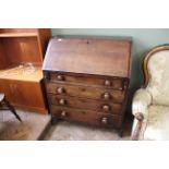 An early Victorian mahogany four drawer bureau on splayed feet (interior as found)
