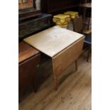 A 1960's beech and elm drop leaf table