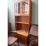 A 1970's display unit with cupboard base and glazed upper section