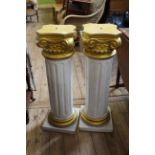 A pair of fluted 20th Century fluted composition pedestals with Corinthian column tops and gilt