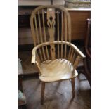 An early 19th Century elm high back Windsor chair with pierced splats